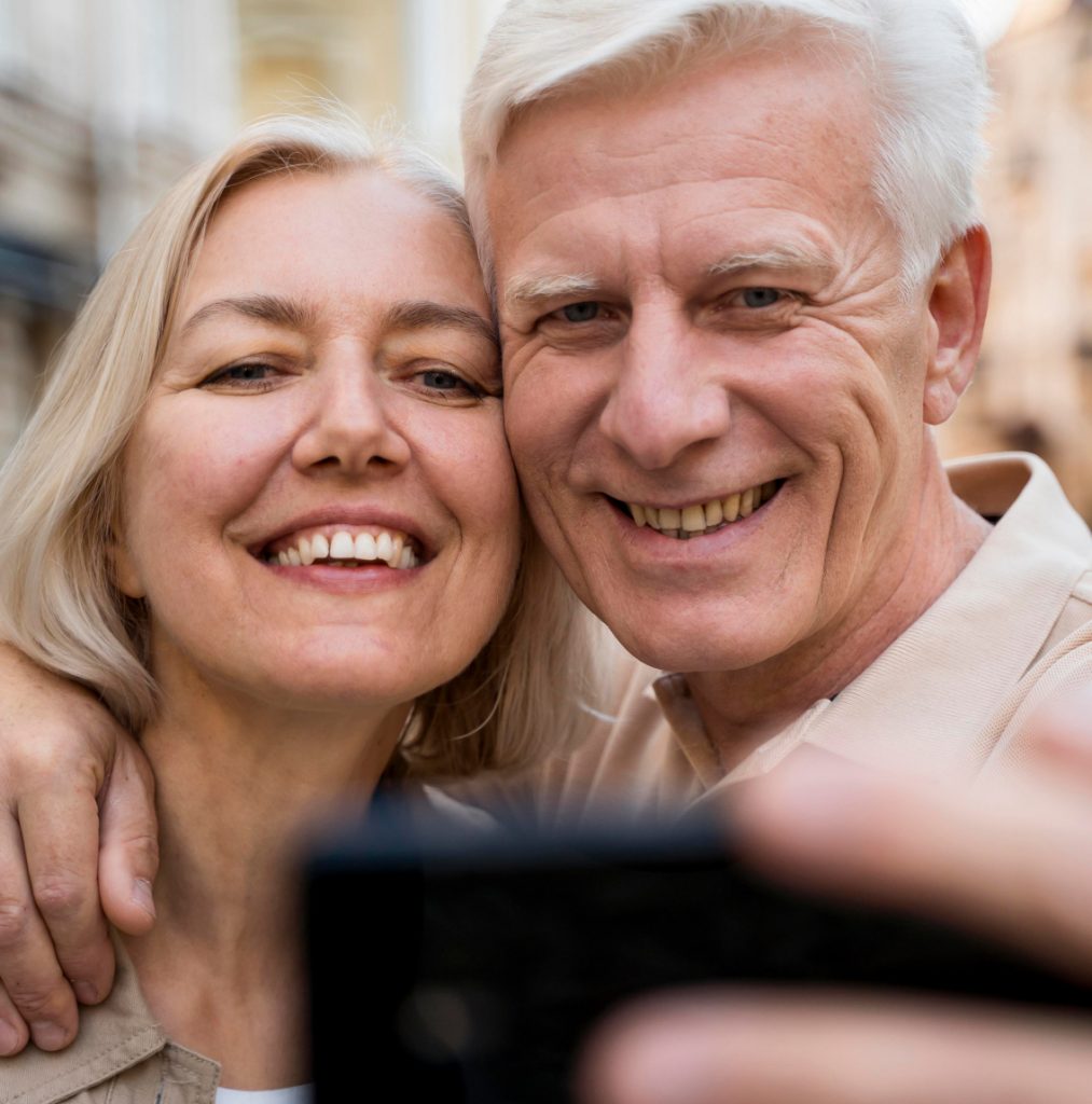 A smiling couple taking a selfie while on holidays