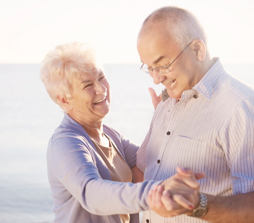 A happy elderly couple dancing able to listen to the music with OTC Hearing Aids